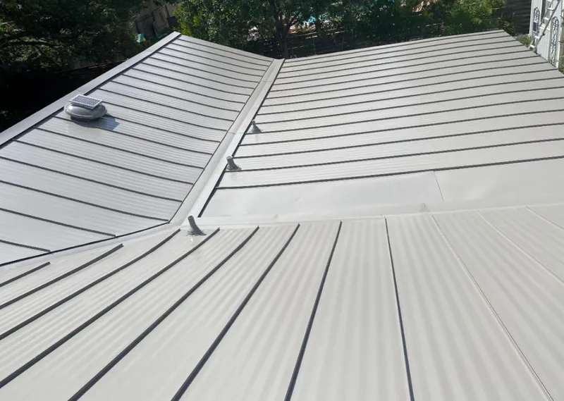 Solar attic fan installed on a metal roof for Roof Ventilation in Park Forest